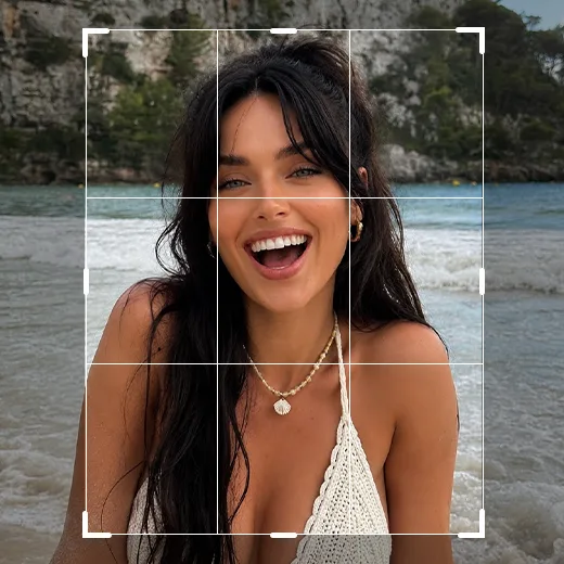 Crop tool grid overlay on a smiling woman in a white bikini at the beach